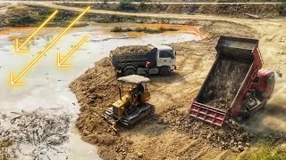 Clearing Water Pond For The Construction of a New School By mini Bulldozer And Truck In Progress