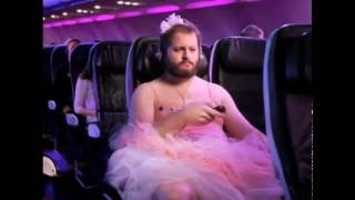 Guy wearing pink tutu on airplane