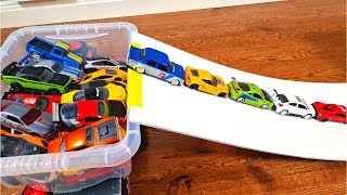 Various Bigger and Smaller Diecast Model Cars Moving Down On Slider *