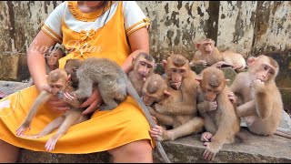 Everyone sitting up nearby mom looks sad face with finger in their mouth wait mom give them milk