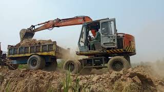 Small hitachi excavator loading mud on tractor🚜 for bricks