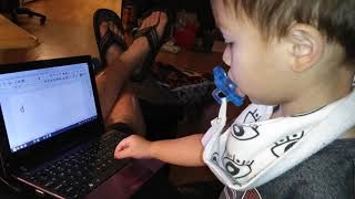 Jace practicing ABC's on laptop