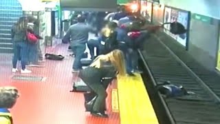 Woman falls onto subway tracks as train pulls into the station