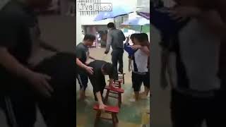 R E S P E C T    Students use stools to help a teacher cross a flooded courtyard