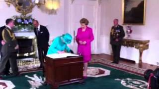 Queen Elizabeth II signing visitors book