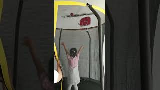 Bouncy Hoops Dream: A Little Girl's Playtime on the Trampoline Basketball Court