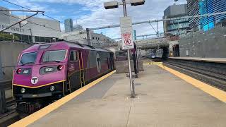 A Passenger Train arrives at Ruggles, Boston, While an Amtrak Acela Passes fast on Another Track