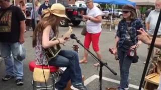 Twins playing their homemade instruments