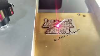 Fiber laser marking machine cutting names on brass