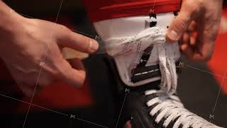 A player in hockey ties laces on skates before the game. Action. Close up of male hands prepares