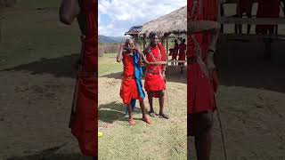 Maasai warrior blows through the snakehorn