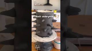 Ceramic artist is making a spikey black vase!