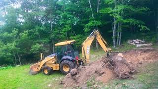 Backhoe tractor clearing my land , getting swimming pool ready