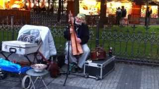 Street artist playing Harp in Staromestske Namesti, Prague