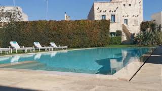 The Pallazzo Ducale Venturi's beautiful pool surrounded by nature