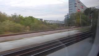 LNER Azuma train from Newcastle approaching Kings Cross passing Arsenal football stadium, 26/4/24.