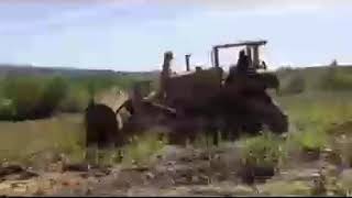 Dozer rolling boulder