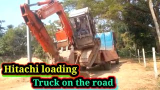 Hitachi loading by Truck on the road