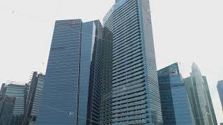 SINGAPORE, JUNE 2018: Aerial footage of Singapore skyscrapers with City Skyline during cloudy summer