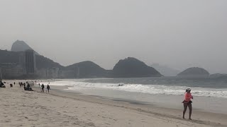 Serene Rio: Waves Crashing on a Cloudy Day