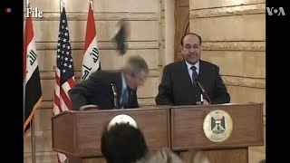 Iraqi journalist Muntadhar al-Zaidi throws his shoes at George W. Bush