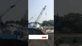 Chinese mobile crane unloading coal from a ship