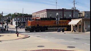 BNSF 6013 leading CPKC 252 past Chicago St (Elgin, IL) with a KCS mid-DPU