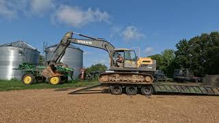 Volvo 220D excavator unloading off the M870A1