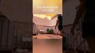 Guy destroys a wall with a ball