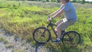 MOUNTAIN BIKE POPPING WHEELIES AT THE LAKE