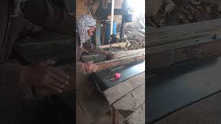 A man cutting wood on saw machine