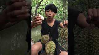 Survival skills | primitive boy eating durian in the rainforest