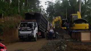 Dump Trucks Unloading Materials and Excavators Working on Road Projects