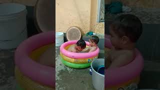 Two small children playing with water. Funny play #cutelittlechild