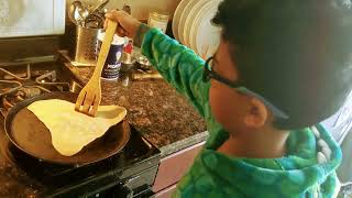 Helping mom in making chapatis