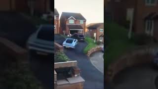 Idiot trying to park a Porsche on his driveway