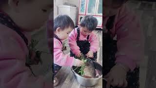 Baby takes vegetables to feed fish