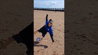 Ninja.Harrison jumps on football at the beach