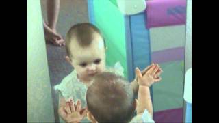 1 year old socializing with her mirror reflection