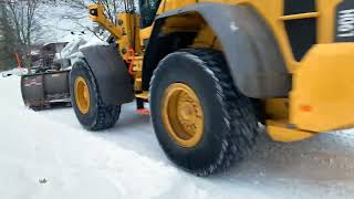 Volvo L90H loader plowing residential streets after a major snowfall