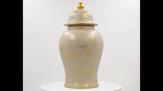 A ceramic ginger jar with lid featuring a light brown and gold marble pattern