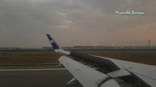 Landing at IGI Delhi airport amidst stormy weather and sunrise.