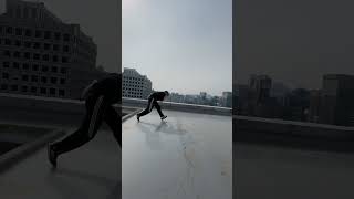 Guy Jumps Over Large Slats on Roof of Skyscraper - 1536160