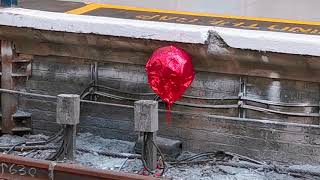 red balloon bobbing by the tracks at London Victoria