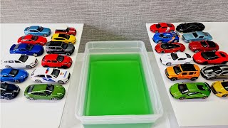 Small cars falling into green water *