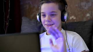 Young boy at home with laptop