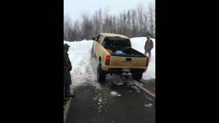 Lifted gmc Sierra climbing snow bank