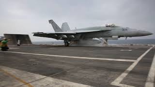 F/A-18 Super Hornets launch and recover aboard the aircraft carrier