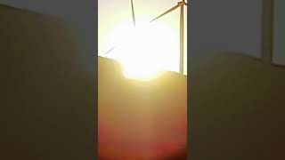 Sunset behind a wind turbine.