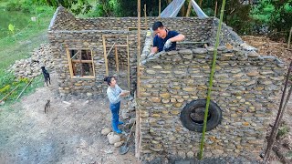 The wife cooks and helps her husband build solid stone house - Build log cabin with many stone